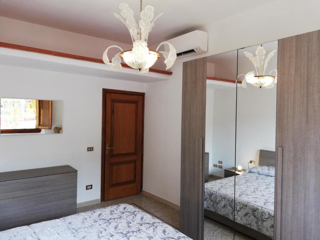 a bedroom with a mirror and a bed and a chandelier at Prato Barone a Firenze in Florence