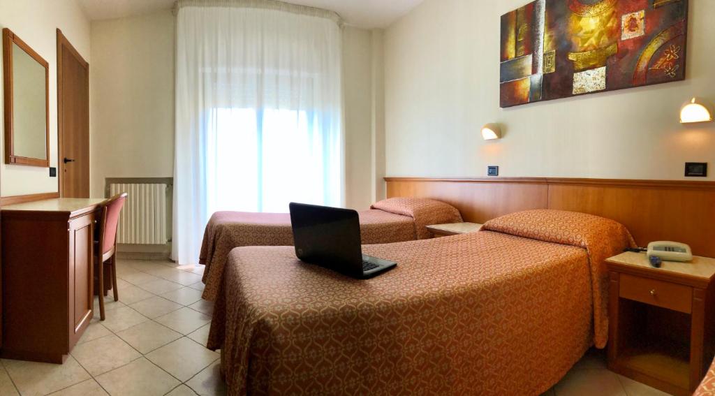 Postel nebo postele na pokoji v ubytování Hotel Sollievo