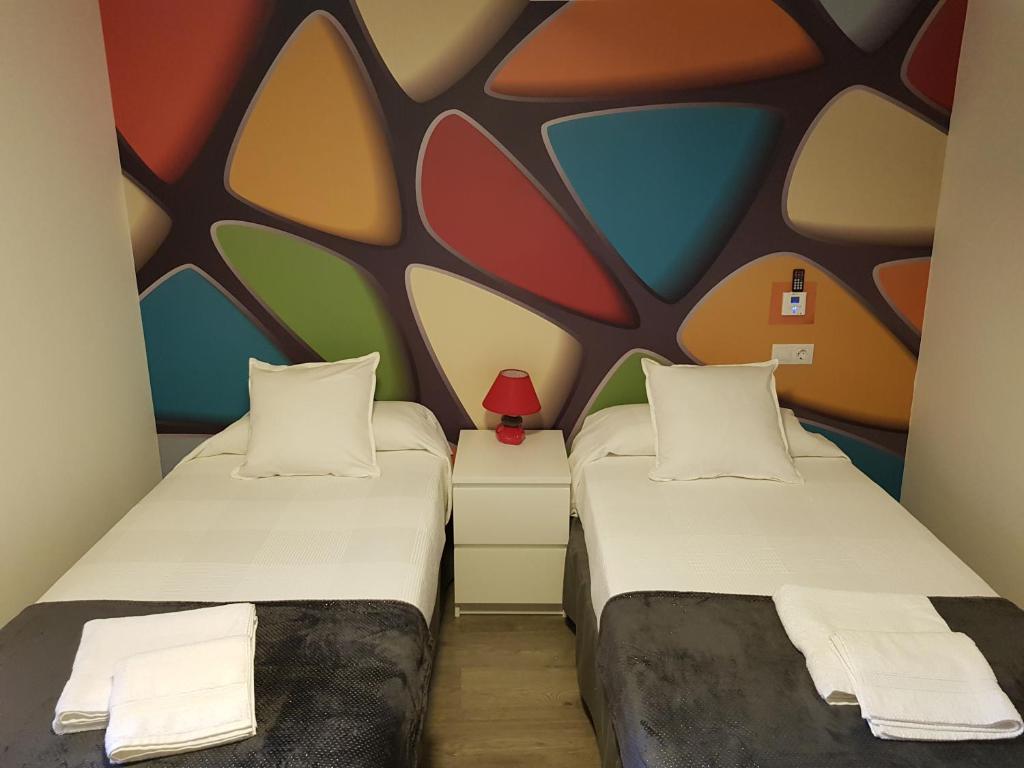 Postel nebo postele na pokoji v ubytování Apartamentos Sueños de Toledo