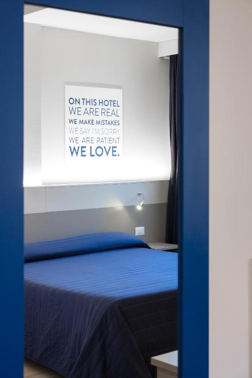 Postel nebo postele na pokoji v ubytování Hotel Martini