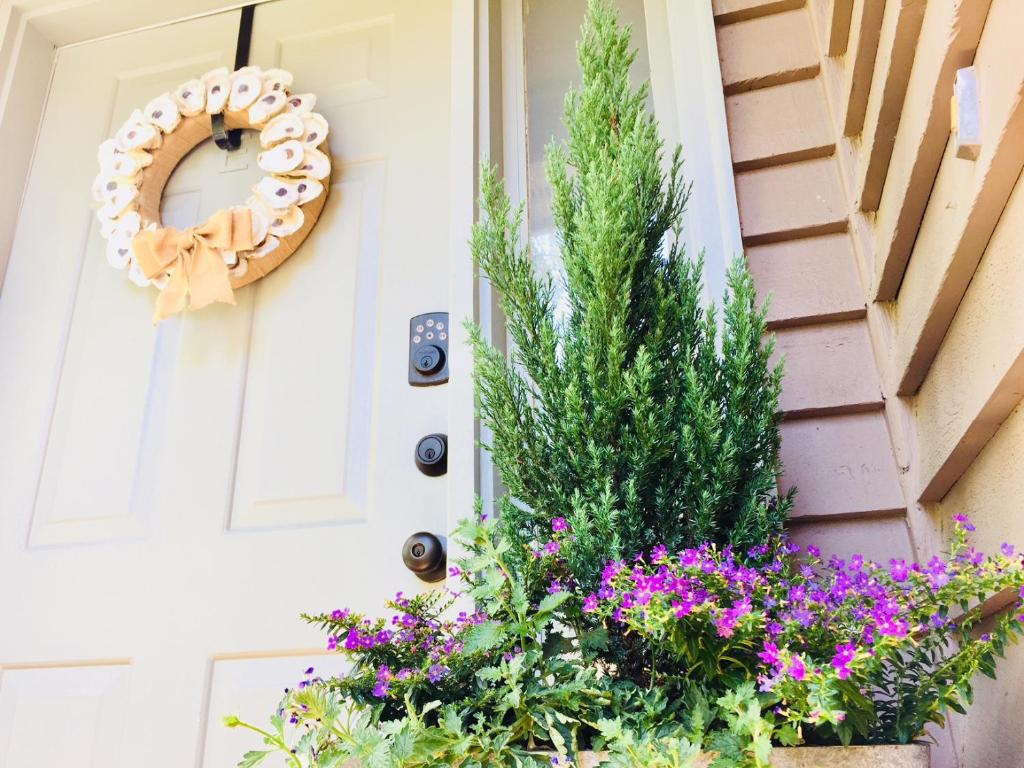 a front door with flowers and a wreath at Southern Sophistication at the Park in Charleston