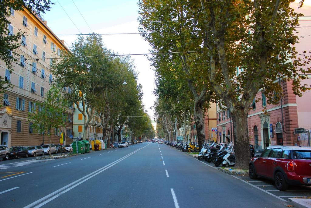 an empty street with cars parked on the side of the road at L'Amande in Genoa