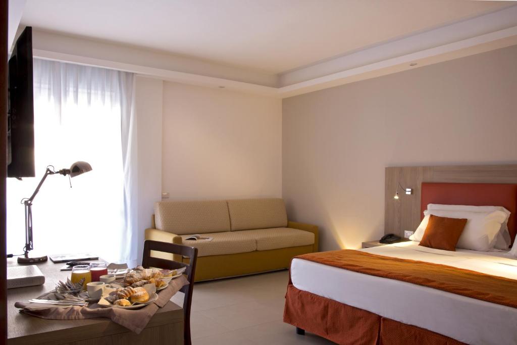 Łóżko lub łóżka w pokoju w obiekcie American Hotel
