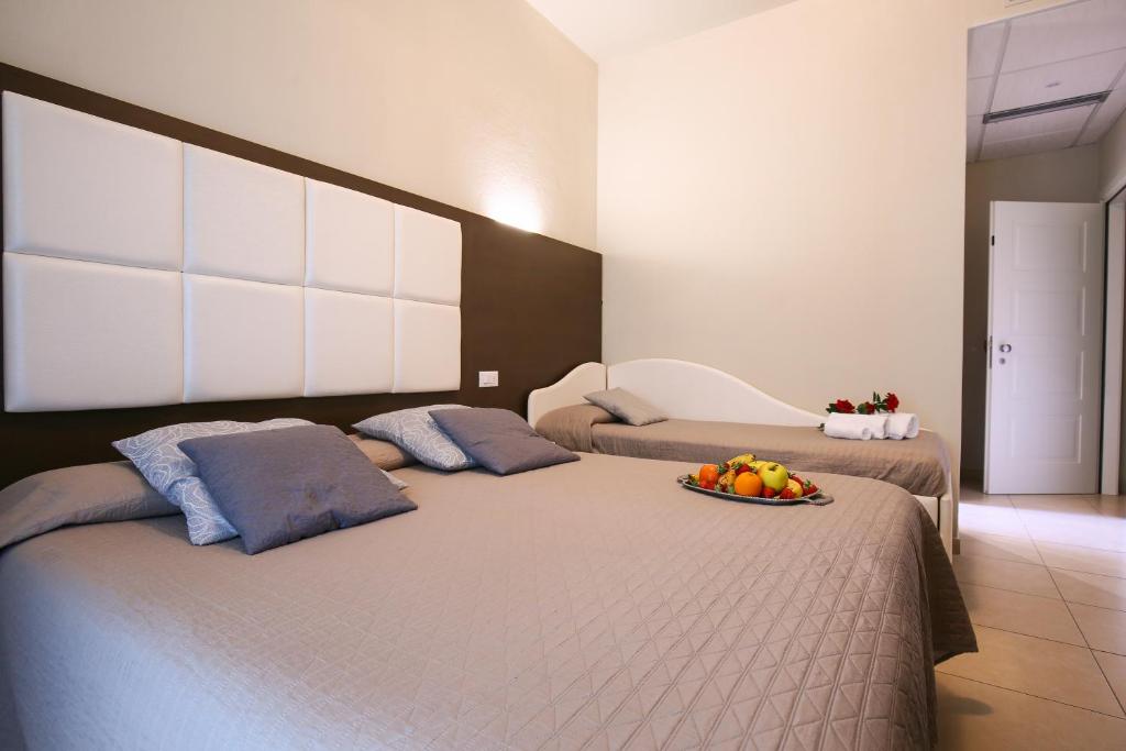 Postel nebo postele na pokoji v ubytování Hotel Bergamo