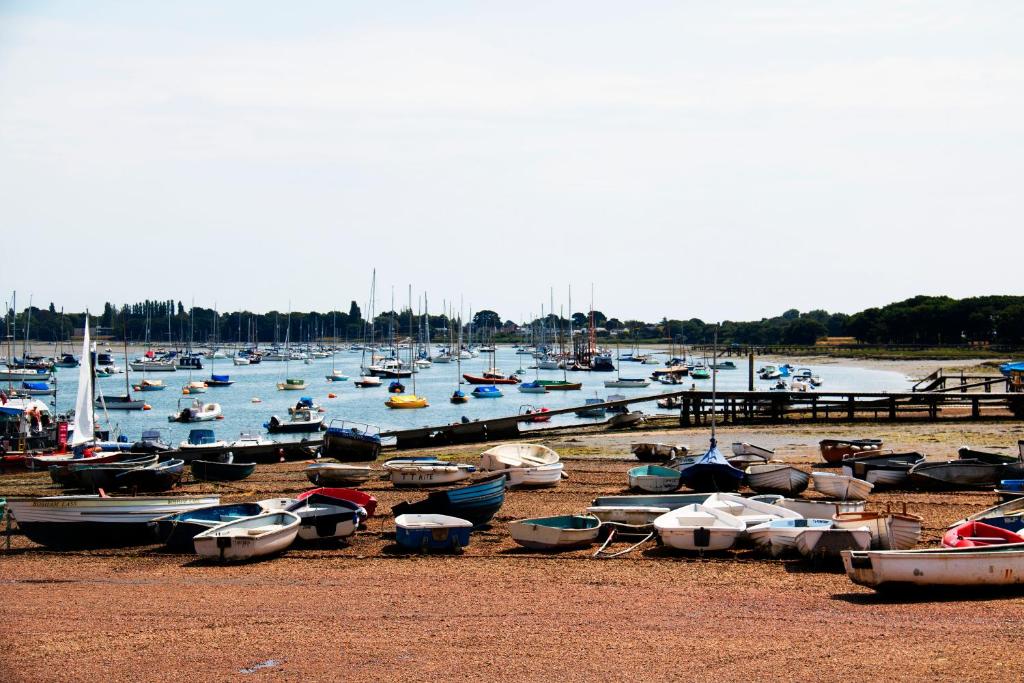 a bunch of boats sitting on the beach at Willow House B&B in West Wittering