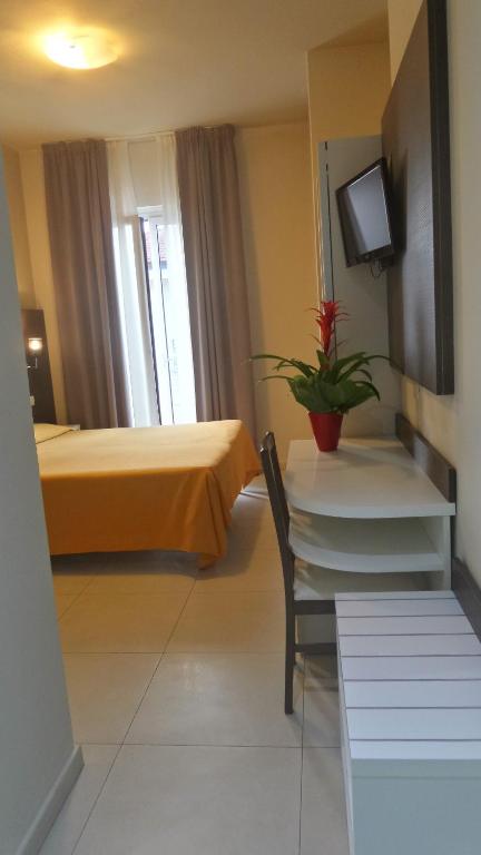 Postel nebo postele na pokoji v ubytování Hotel Bergamo
