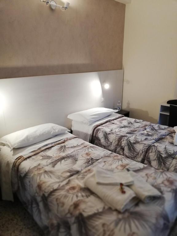 Postel nebo postele na pokoji v ubytování Hotel Tosi