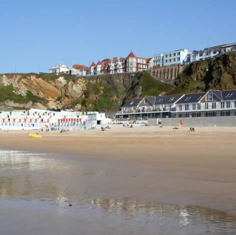 a beach with a group of people and buildings at Harrington Guest House in Newquay