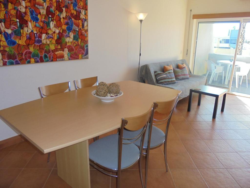 a dining table and chairs in a living room at CasaDuarte "doMar" in Lagos