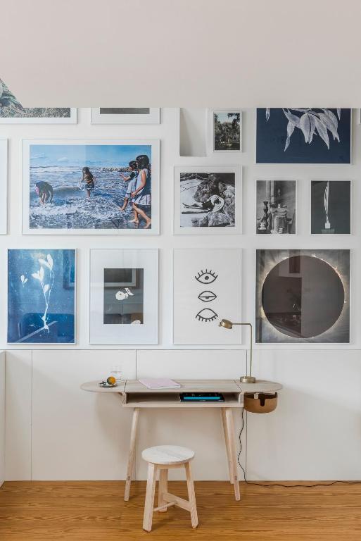 a room with a desk and pictures on the wall at Flattered to be in Porto in Porto
