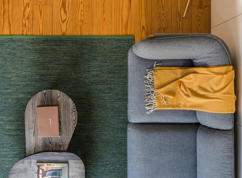 a blue couch with a wooden spoon next to it at Flattered to be in Porto in Porto