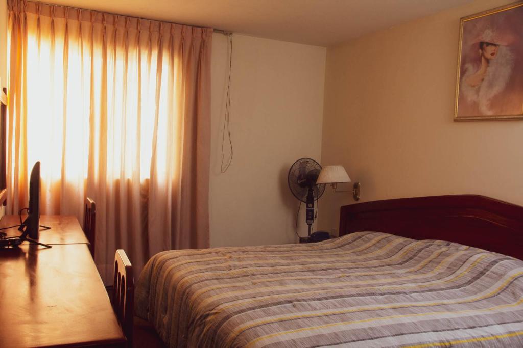 Ένα ή περισσότερα κρεβάτια σε δωμάτιο στο Hotel Internacional