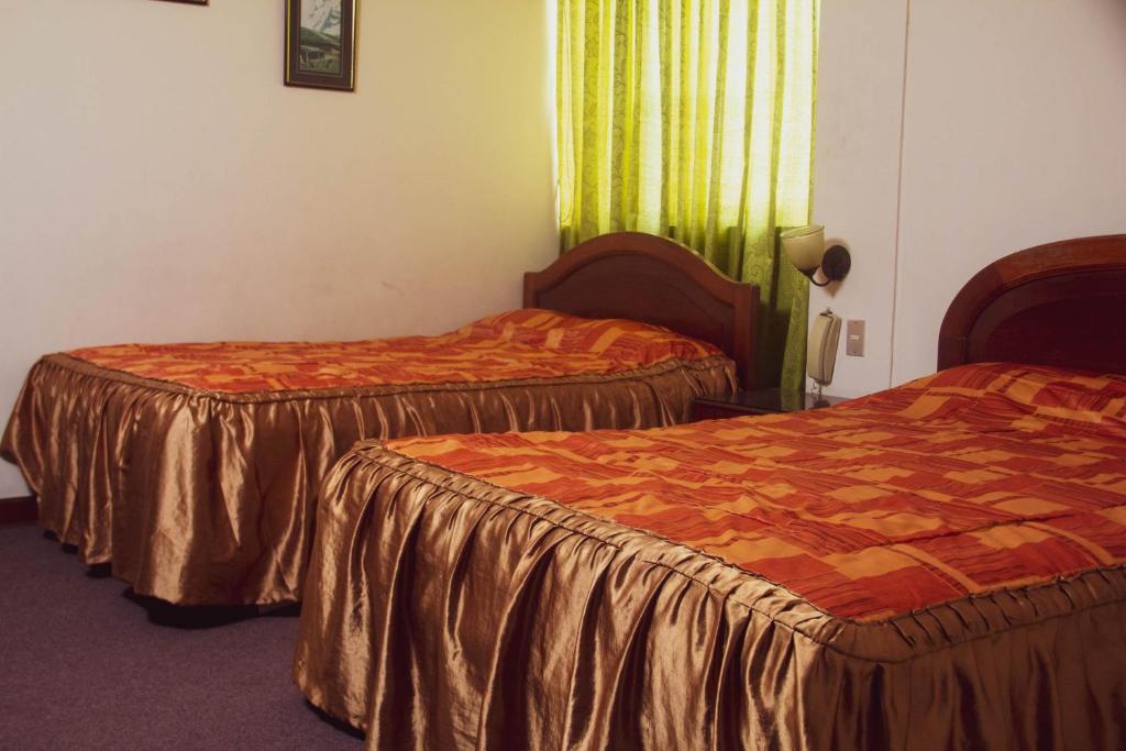 Ένα ή περισσότερα κρεβάτια σε δωμάτιο στο Hotel Internacional