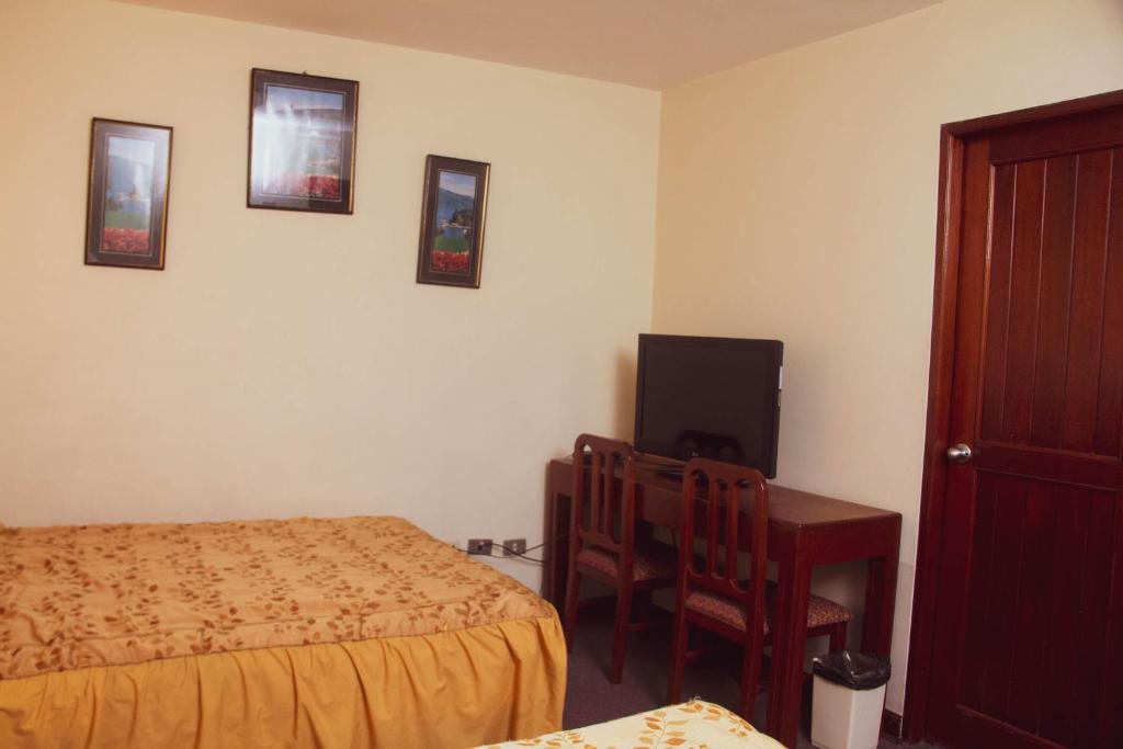 Ένα ή περισσότερα κρεβάτια σε δωμάτιο στο Hotel Internacional