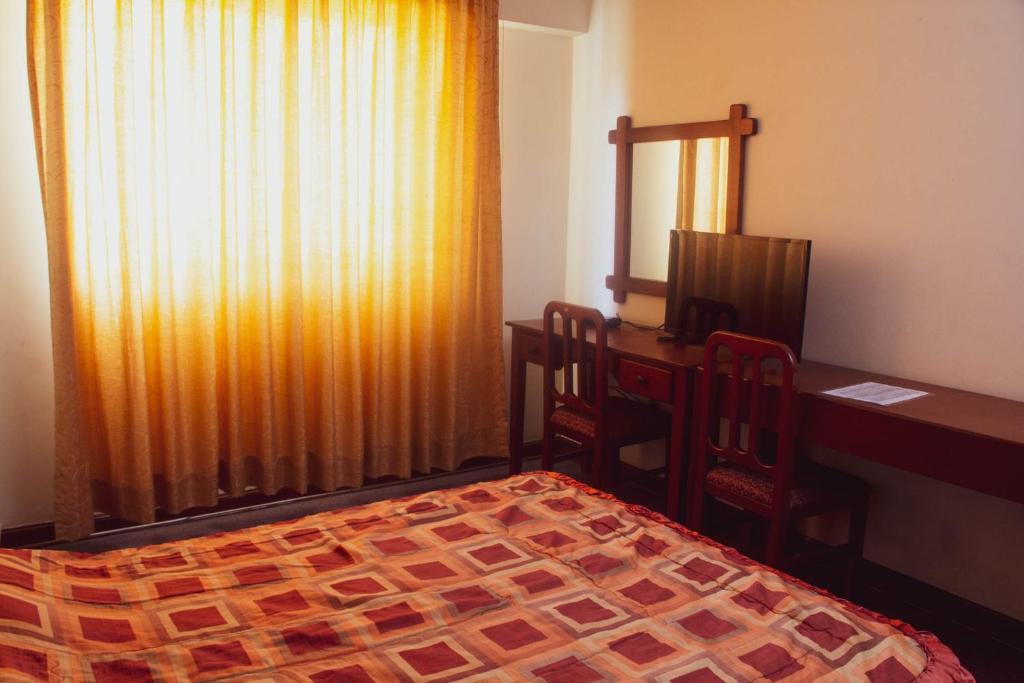 Ένα ή περισσότερα κρεβάτια σε δωμάτιο στο Hotel Internacional