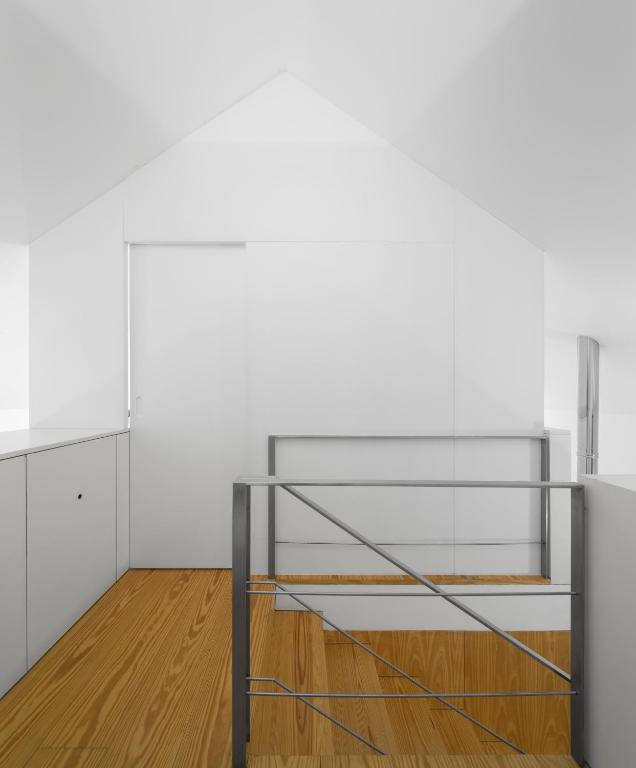 a metal shelf in a room with a wooden floor at Flattered to be in Porto in Porto