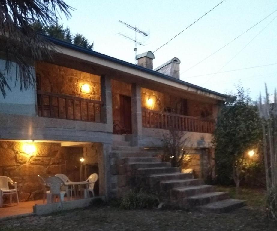 a house with stairs leading up to it at night at Casa da Costeira in Figueiró