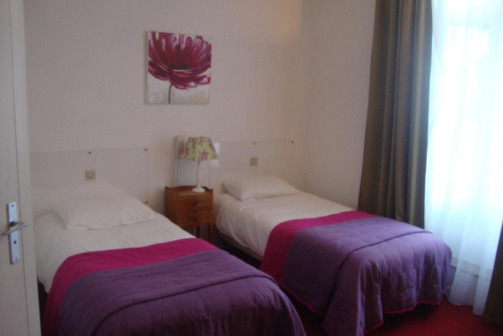 Postel nebo postele na pokoji v ubytování Hotel LE BEAU SITE