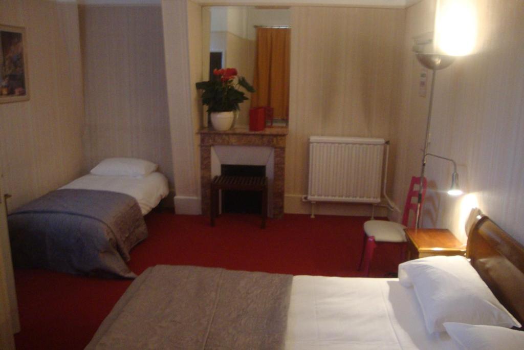Postel nebo postele na pokoji v ubytování Hotel LE BEAU SITE