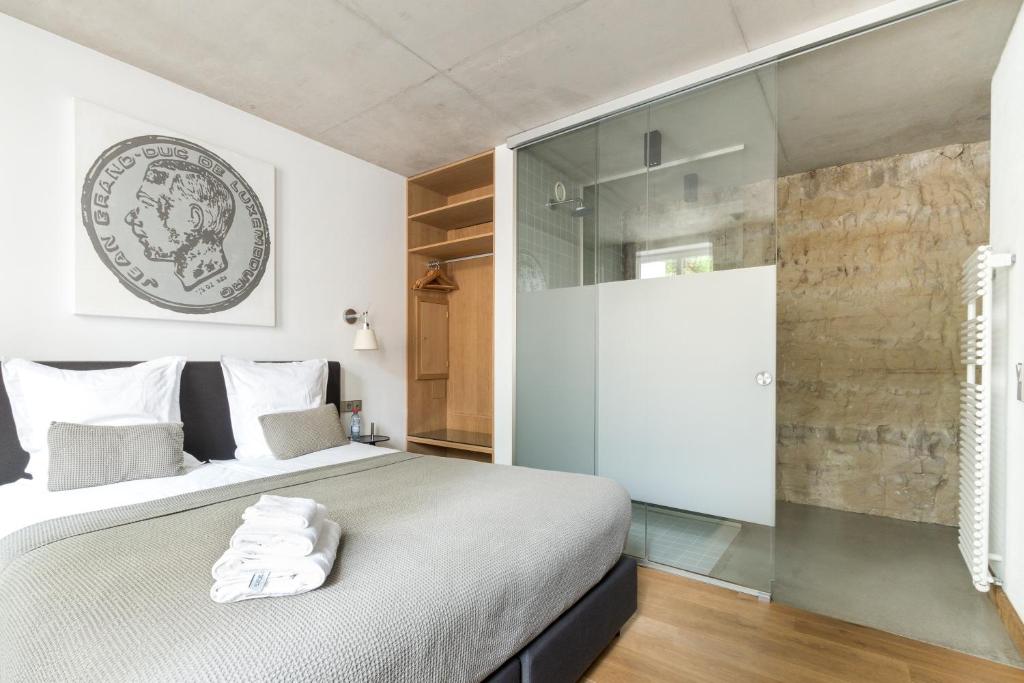 a bedroom with a bed and a sliding glass door at La Pipistrelle Hotel in Luxembourg