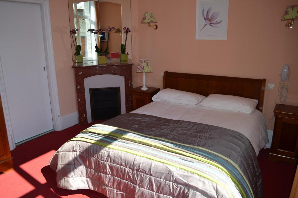 Postel nebo postele na pokoji v ubytování Hotel LE BEAU SITE