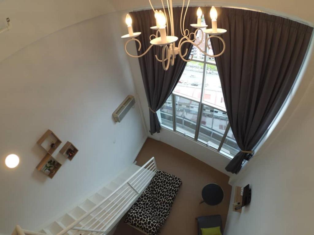 an overhead view of a room with a chandelier and a window at Comfort Zone @ The CEO Loft by Joal in George Town