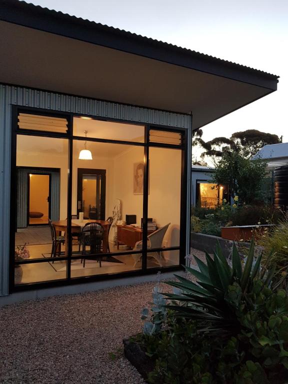 a conservatory with sliding glass doors on a house at Sinclair Eco House in Port Lincoln