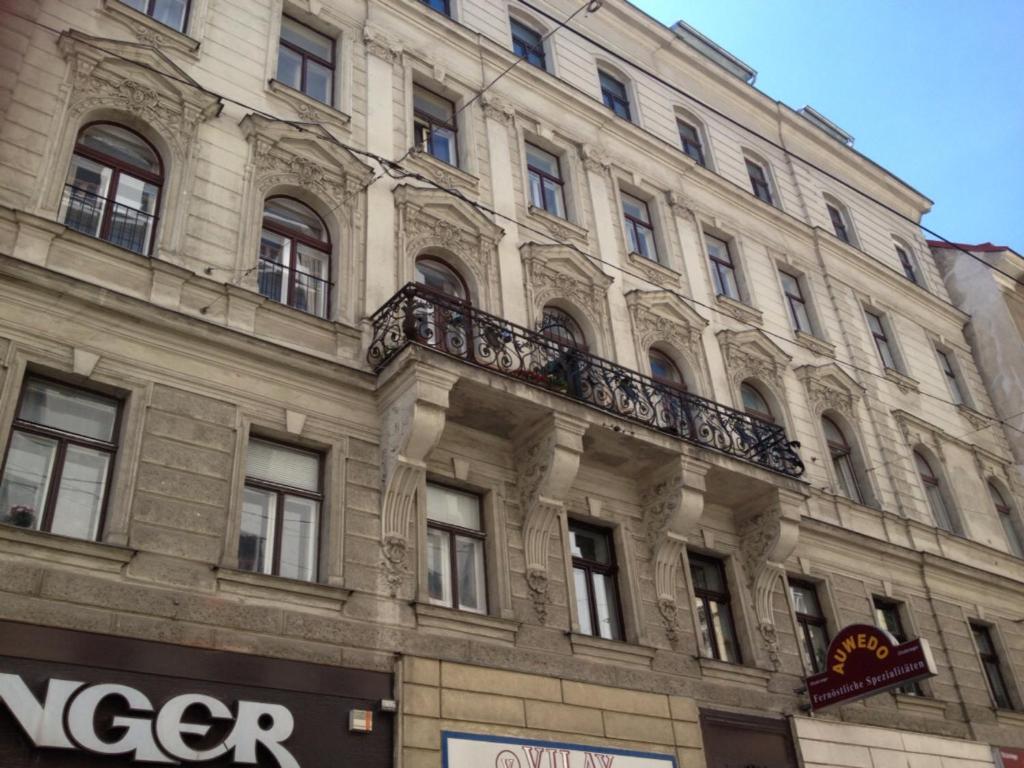 a large building with a balcony on the side of it at Walzhofer Apartement in Vienna