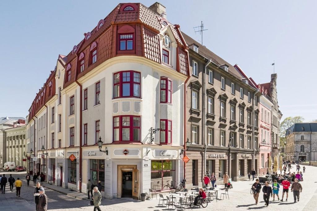 a large building with red windows on a city street at Great apartament in a heart of Tallinn in Tallinn