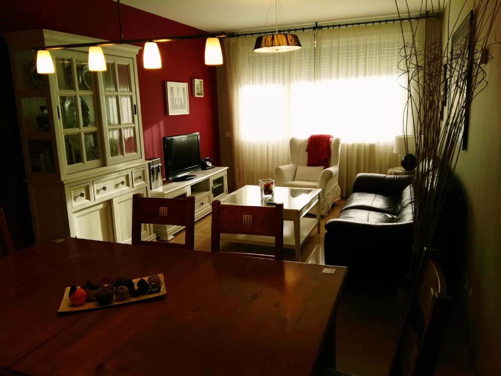 sala de estar con mesa y sofá en APARTAMENTO HARINERA-AOIZ, en Aoiz