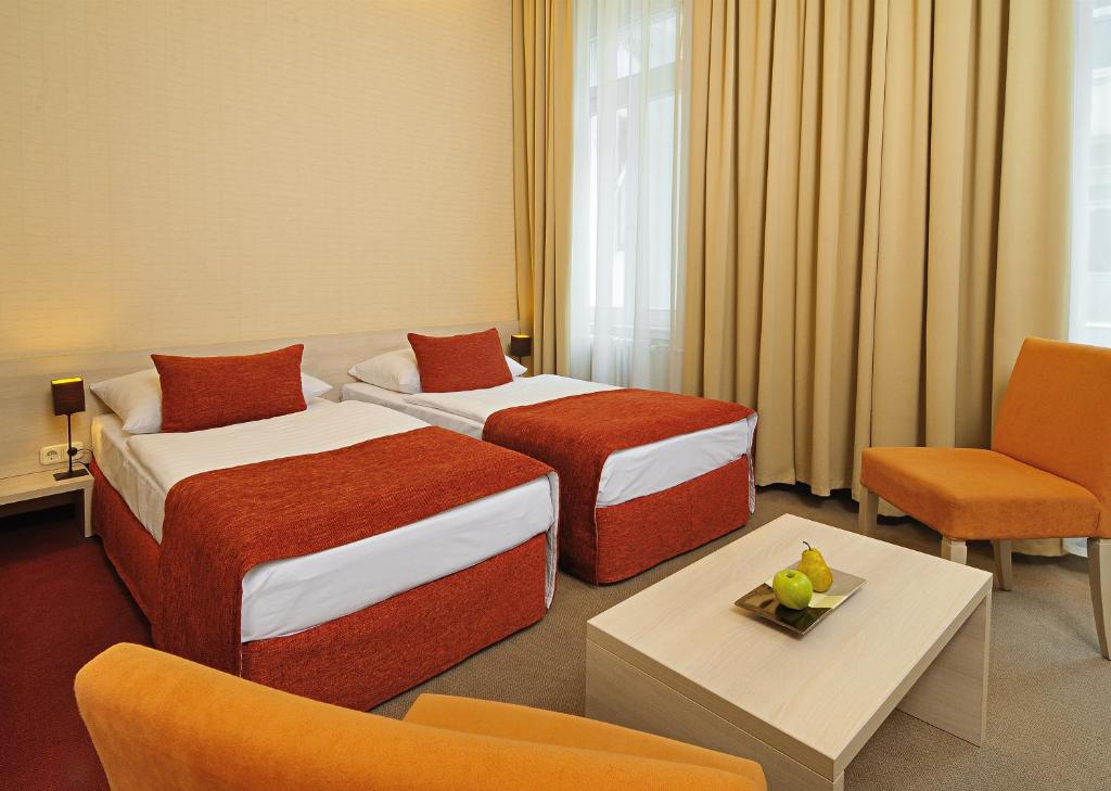 Postel nebo postele na pokoji v ubytování Star City Hotel