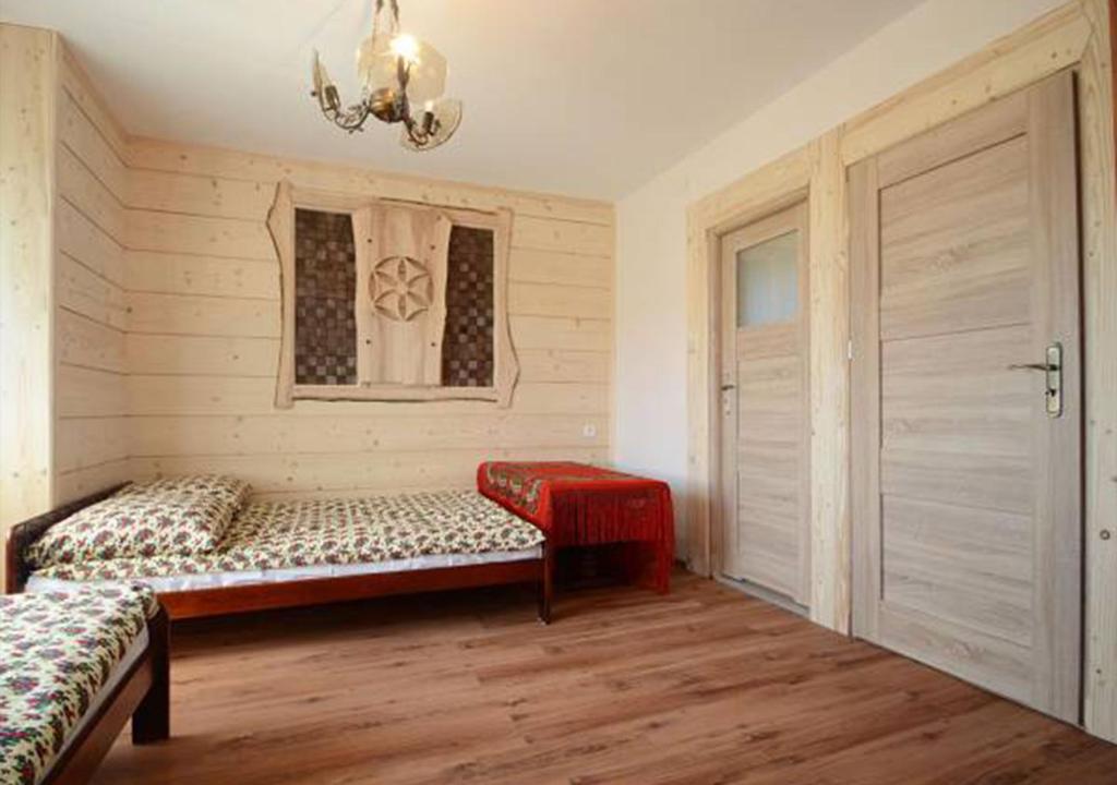 En eller flere senge i et værelse på Pokoje u Petra