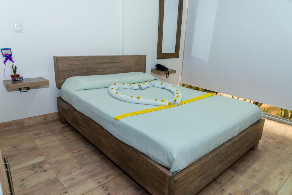 Postel nebo postele na pokoji v ubytování Hotel Barbacoa Uraba