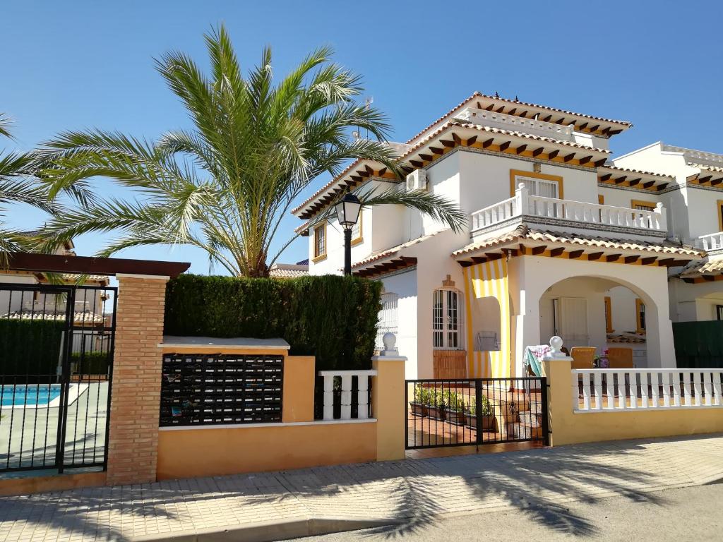 a villa with a pool and palm trees at Luxury and comfort in La Marina, with sea views at El Pinet beach in La Marina