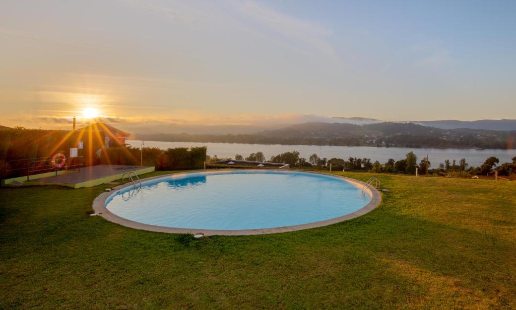 uma piscina com vista para um lago em River-side Villa em Vila Nova de Cerveira