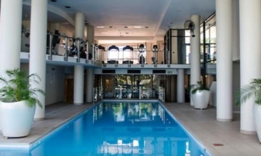 a large swimming pool in a building with columns at Home relaxation in the city in Cape Town