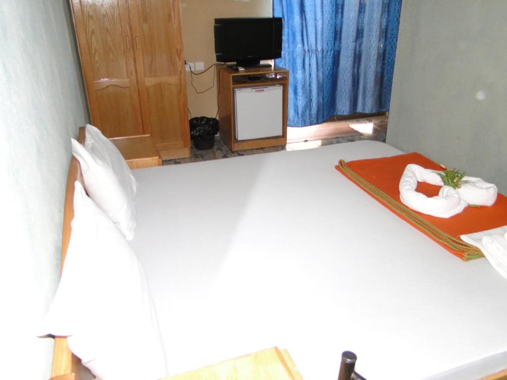 a hotel room with a bed with towels on it at Arab Divers Dive Center and Bed & Breakfast in Aqaba