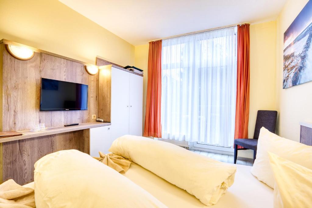 Postel nebo postele na pokoji v ubytování Hotel Kiebitz an der Ostsee