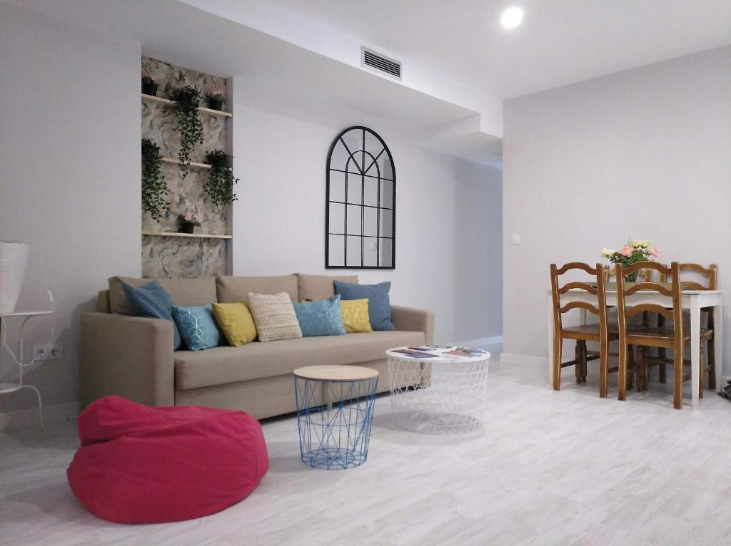 a living room with a couch and a table at Apartamento centro san blas 36, próximo al Pilar in Zaragoza