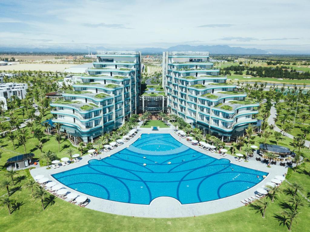 an aerial view of a resort with a large swimming pool at Vinpearl Resort & Golf Nam Hoi An in Hoi An