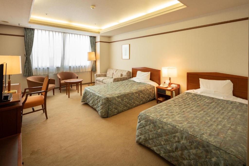 Postel nebo postele na pokoji v ubytování Hotel Danrokan