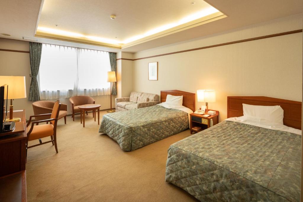Postel nebo postele na pokoji v ubytování Hotel Danrokan
