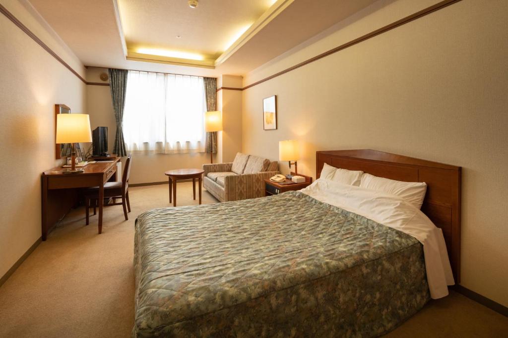 Postel nebo postele na pokoji v ubytování Hotel Danrokan
