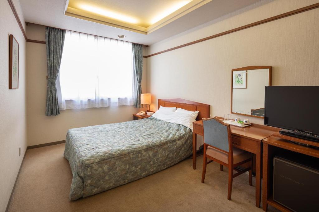 Postel nebo postele na pokoji v ubytování Hotel Danrokan