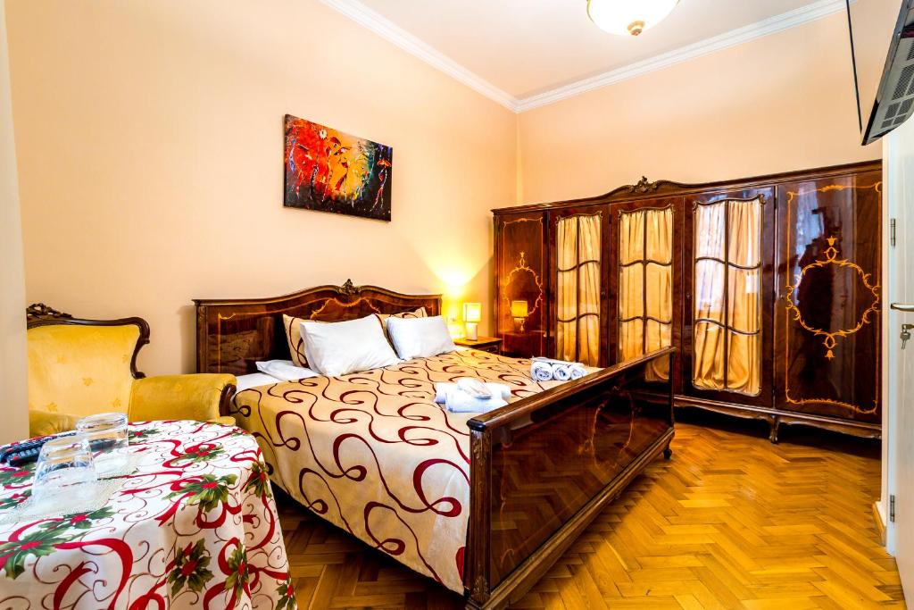 a bedroom with a bed and a dresser at V Park Hotel in Tbilisi City