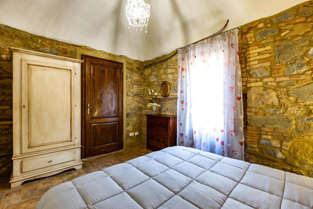 Postel nebo postele na pokoji v ubytování SunMoon Chianni
