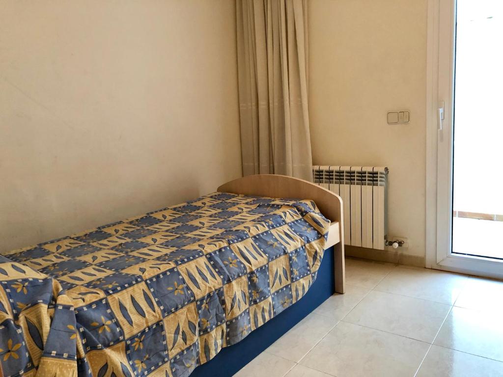 Кровать или кровати в номере Apartamentos Benet