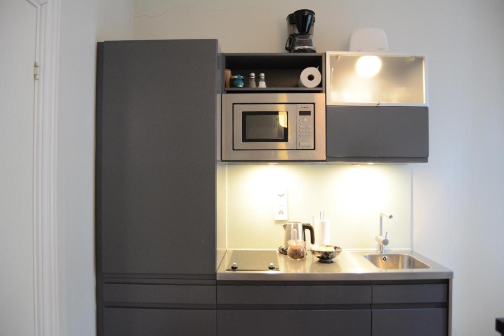 Kuchyň nebo kuchyňský kout v ubytování DA Hotel Apartments