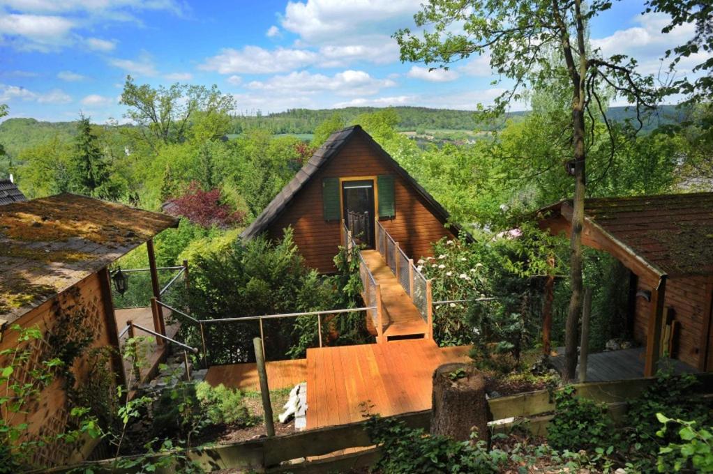 a log cabin with a staircase leading to a door at Ferienhaus 33 Altmühlthal in Kinding