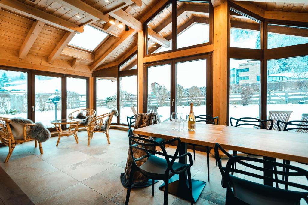 a large room with tables and chairs and windows at Haus Ennsegg by Schladming-Appartements in Haus im Ennstal